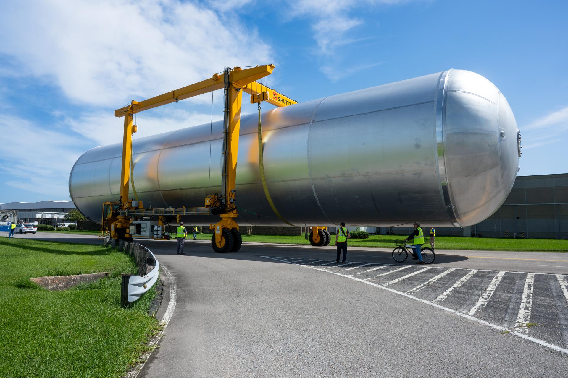 Crews at NASA’s Michoud Assembly Facility in New Orleans transport the 130-foot-tall liquid hydrogen tank from the proof testing building to the main factory on July 15. The liquid hydrogen tank will form part of the core stage for the SLS (Space Launch System) rocket for the agency’s Artemis IV mission, providing thousands of gallons of super-cold propellant to the rocket engines during launch. Soon, teams with SLS prime contractor, Boeing, will move the tank into the facility’s vertical assembly building for cleaning operations.   The liquid hydrogen propellant tank is one of five major elements that make up the 212-foot-tall SLS rocket stage. The core stage, along with its four RS-25 engines at its base, produce more than two million pounds of thrust to help launch NASA’s Orion spacecraft, astronauts, and supplies beyond Earth’s orbit and to the lunar surface for Artemis.      